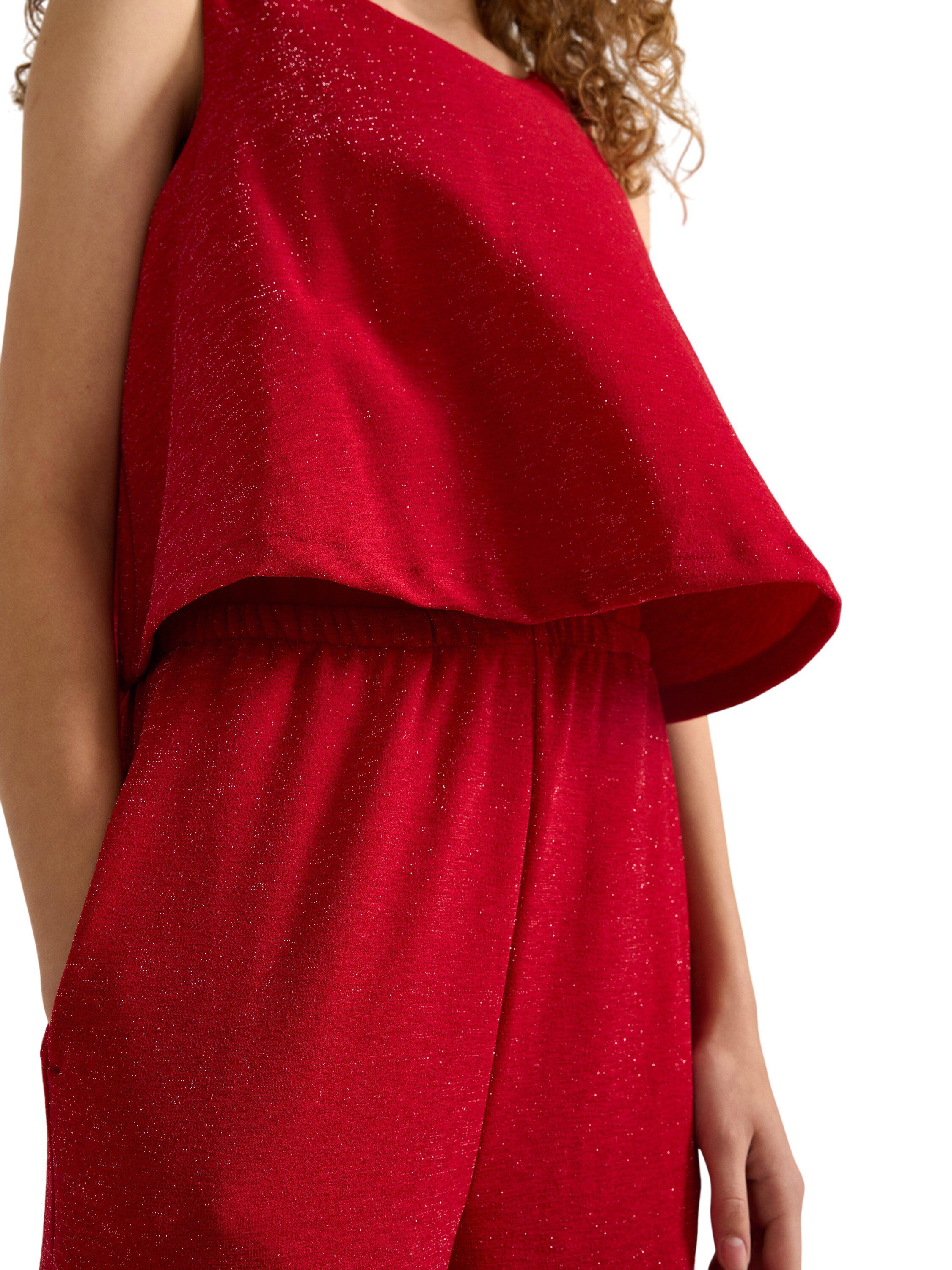 Glitrende, &aelig;rmel&oslash;s buksedragt med b